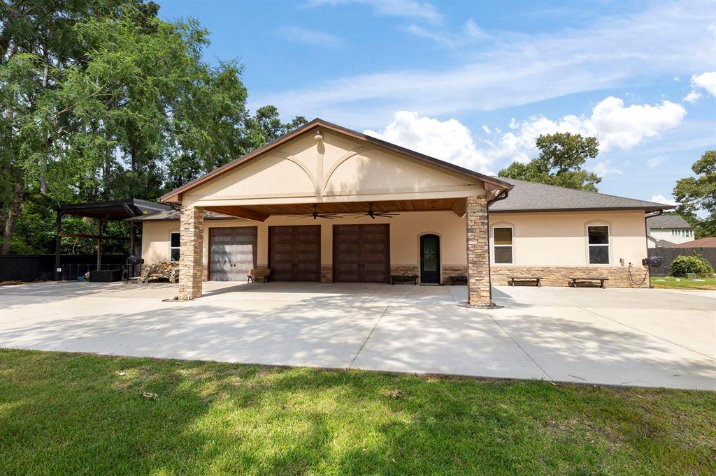 This versatile multipurpose building offers endless potential—whether you envision a guest house, private office, fitness studio, or workshop. RV parking area to the left.
