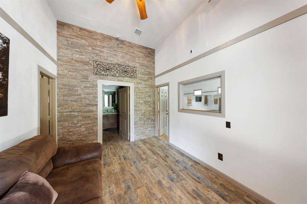 Entryway leads to a full bath straight ahead, a spacious multipurpose room to the right, and oversized garage space to the left.