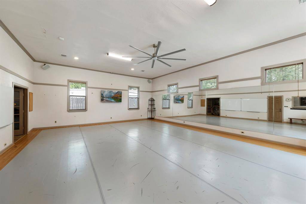 This versatile 34x25 space, currently used as a dance studio, features a full bath and kitchenette—offering endless potential to convert into a home office, creative studio, or private guest suite/mother-in-law quarters.