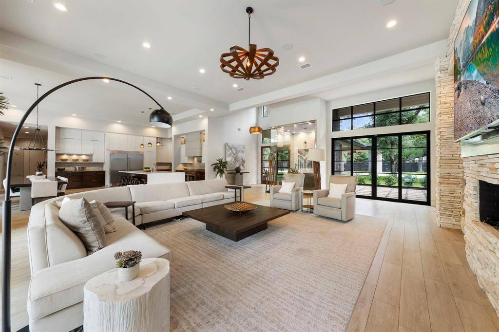 This expansive open-concept living space seamlessly connects kitchen, dining, and lounge areas.