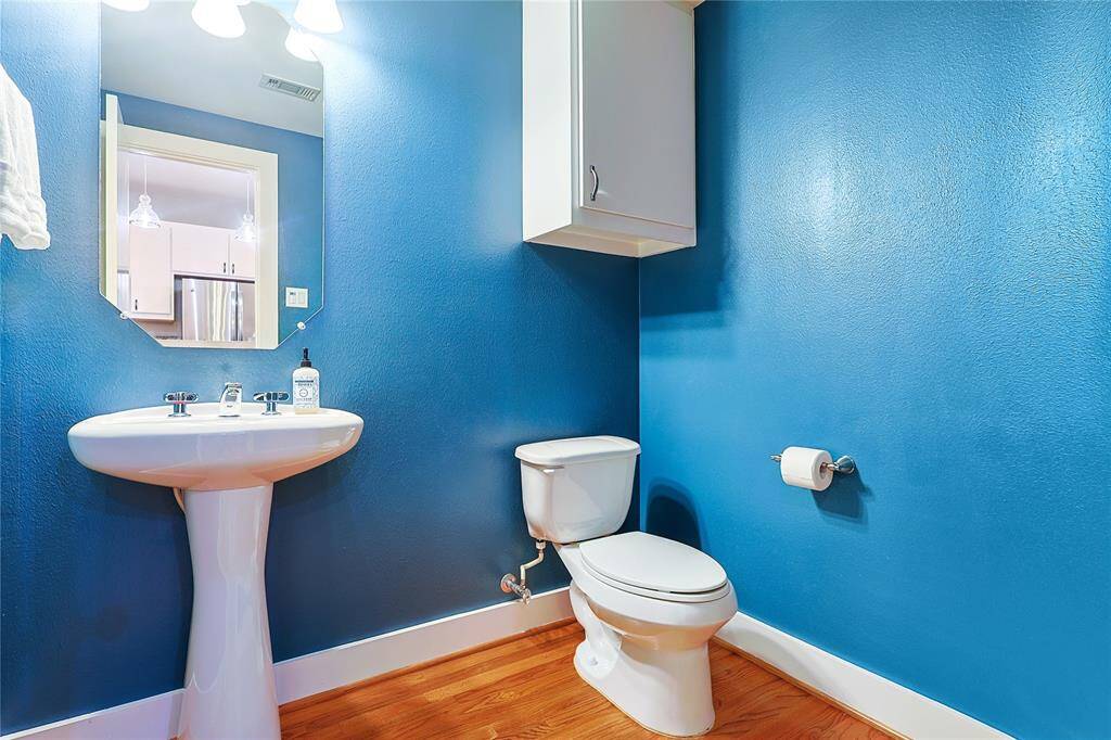Vibrant and spacious powder room with pedestal sink