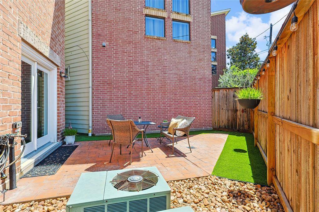 Patio space with a mix of hardscape and turf, ideal for outdoor lounging.