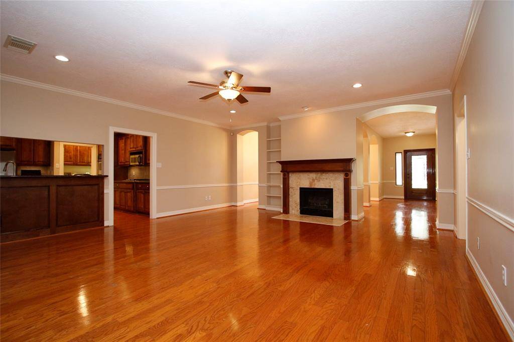 Another view of the family room that features the lovely entry on the right and entrance to kitchen on left.