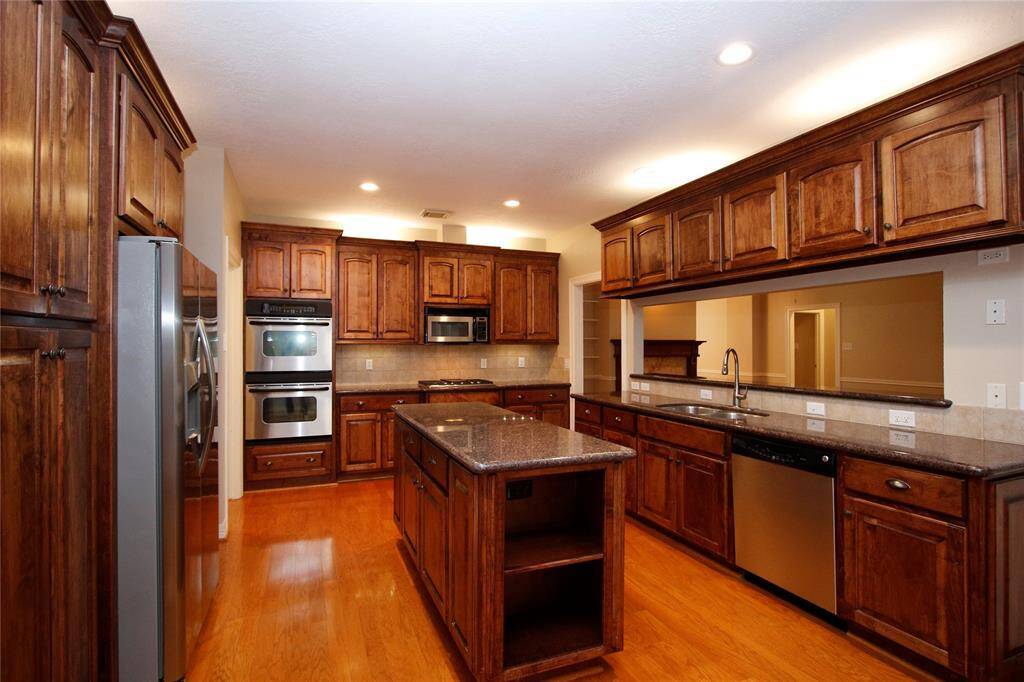 Storage, storage, storage.  Recessed lighting, over cabinet lighting and under cabinet lighting -- spacious and bright.  Double ovens, 5-burner cooktop  -- stainless appliances throughtout.