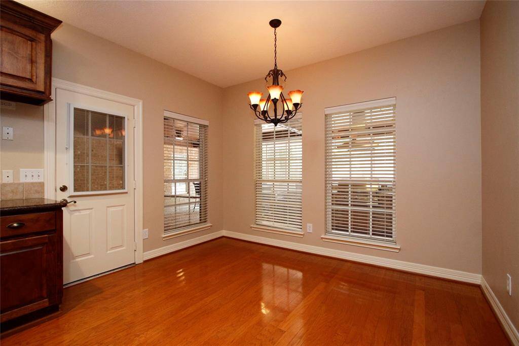 Cozy breakfast area with lovely  chandelier and ample natural light from windows--all windows feature white blinds.  Just off the kitchen so you can grab a quick bite before heading out for the day.