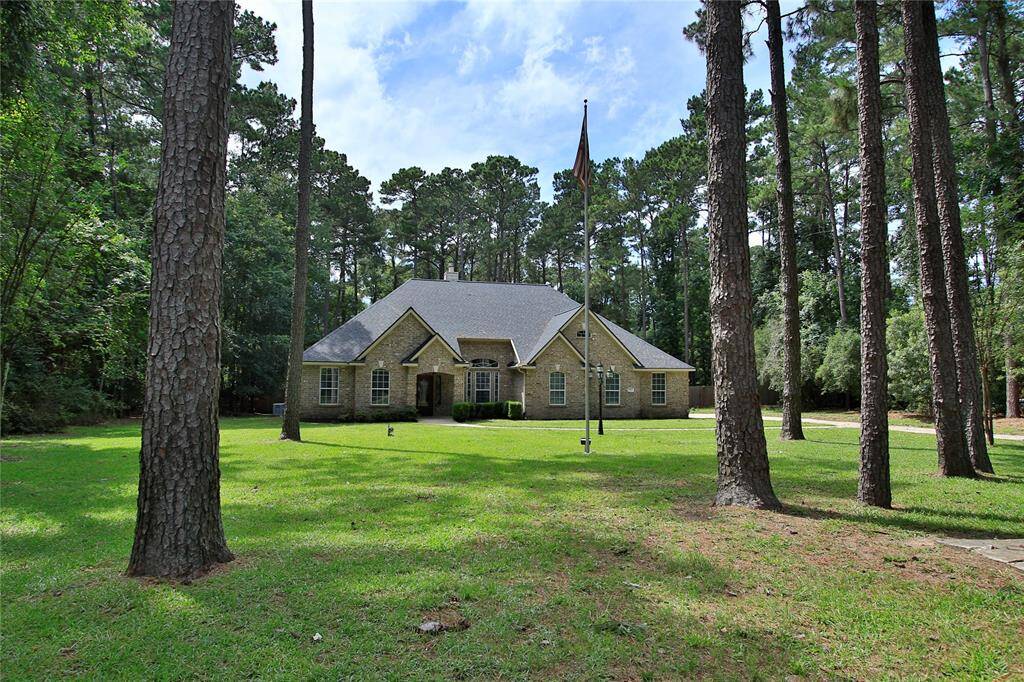 The home is surrounded by a lush, wooded landscape. The spacious yard includes sprinkler system front & back. You will have privacy and a serene, natural setting to come home to every day.