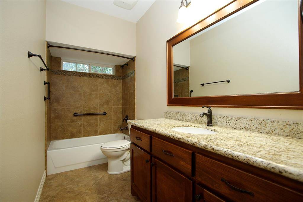 This bathroom is between the 2nd and 3rd bedrooms.  Continues the custom cabinets, granite counters, framed mirrors and has storage closet as well.