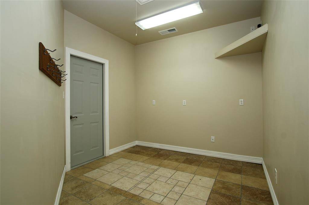 This utility room is across from the laundry room and also has access to the garage.  Plenty of space for that extra fridge or freezer.