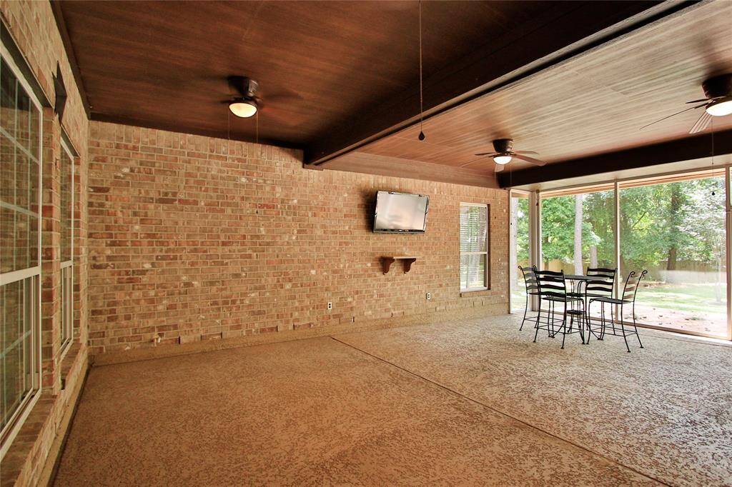 This spacious screened-in patio features brick walls, several ceiling fans, and beautiful wood ceiling.  This area is so inviting -- just perfect for relaxation or entertaining.