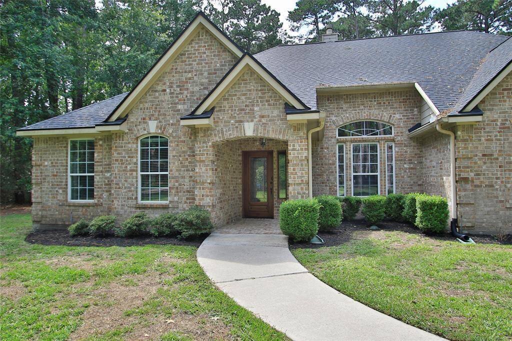 The curved walkway leads your family & friends to a covered entry with low maintenance landscaping. Just the right  blend of elegance and comfort.
