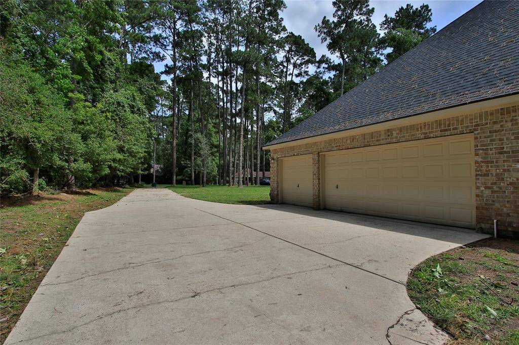 Three car garage with extra parking space and extra long driveway.  Even the driveway is private and serene.