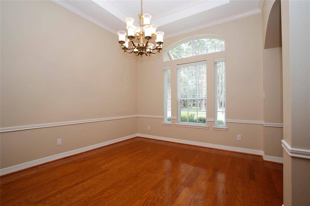 This formal dining room is just to the right as you enter the home.  It features a classic chandelier, and large arched, triple window create an inviting spot for meals and gatherings.  A memory making space.