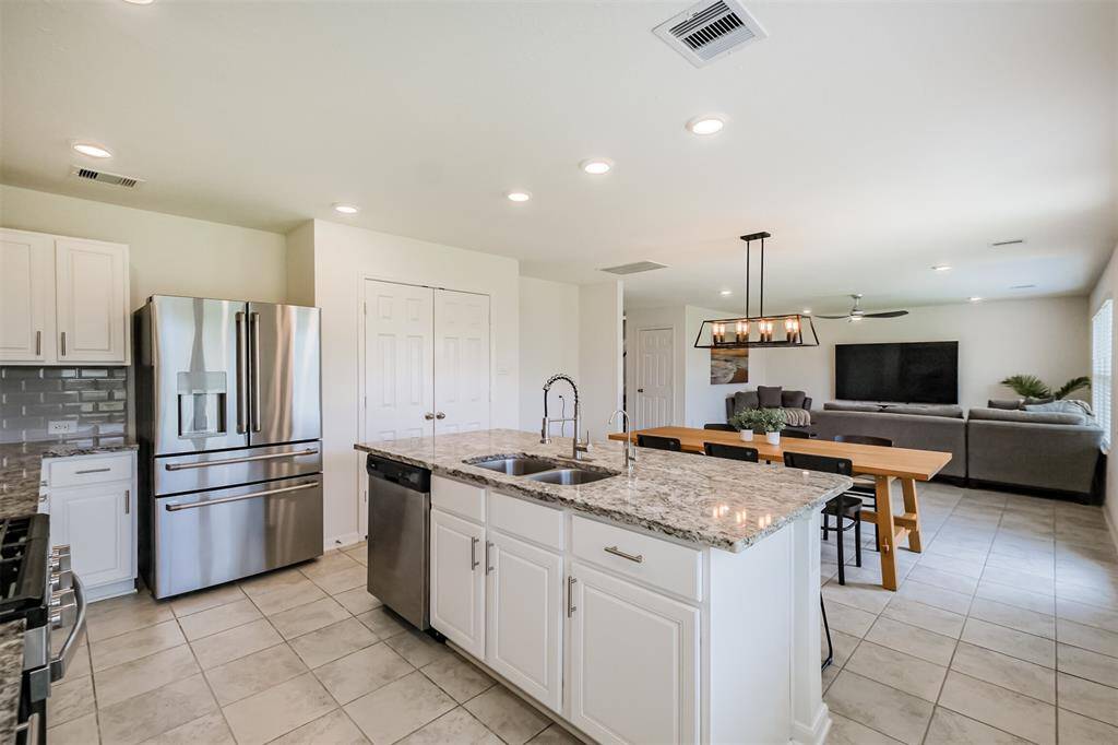 This is where life happens- cooking, laughing, and sharing meals in a space that flows beautifully into the dining and living areas.