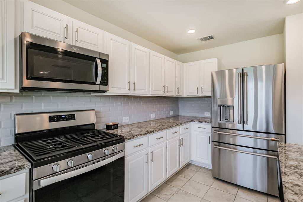 Step into your dream cooking space- fully equipped with stainless steel microwave microwave, stove and a stunning four-door refrigerator.