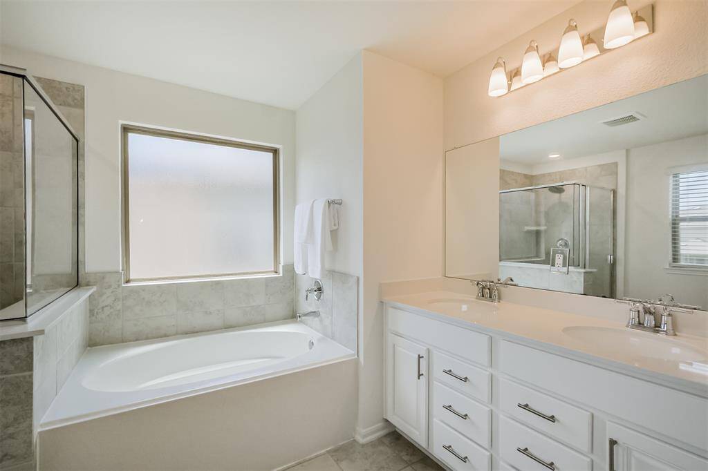 Unwing in your spa- like bathroom, featuring a soaking tub, double sinks and plenty of counter space. It's perfect to start and end your day with ease and comfort.