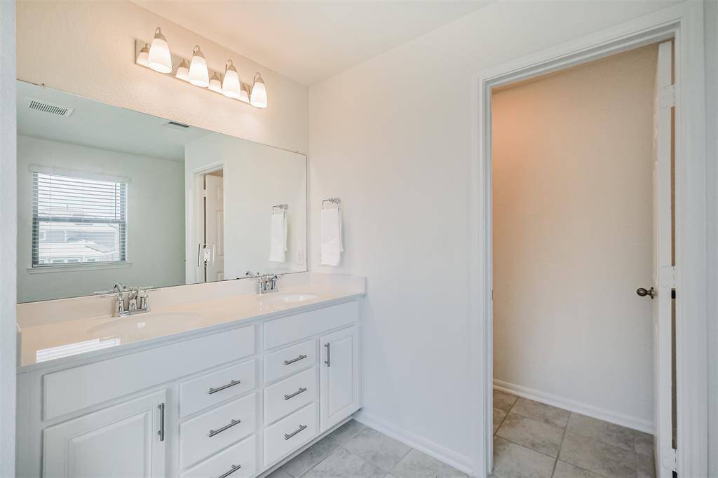 Your bathroom retreat includes double sinks and a private toilet area, offering both style and functionality... every detail supports your daily routine.