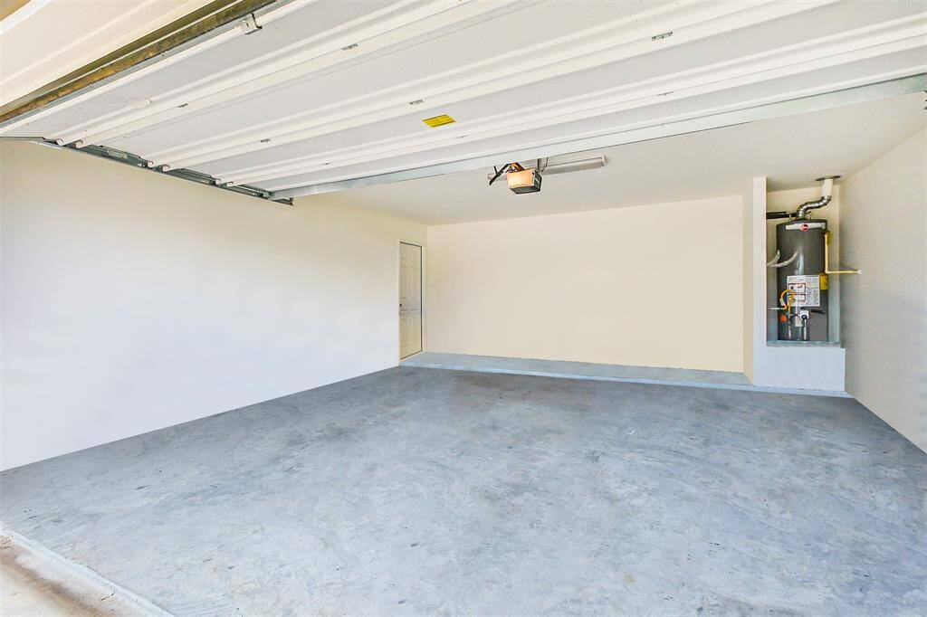 Need extra space? This two car garage is not only equipped with the water heater but also offers tons of room for storage, tools, or even a workshop... possibilities are endless!