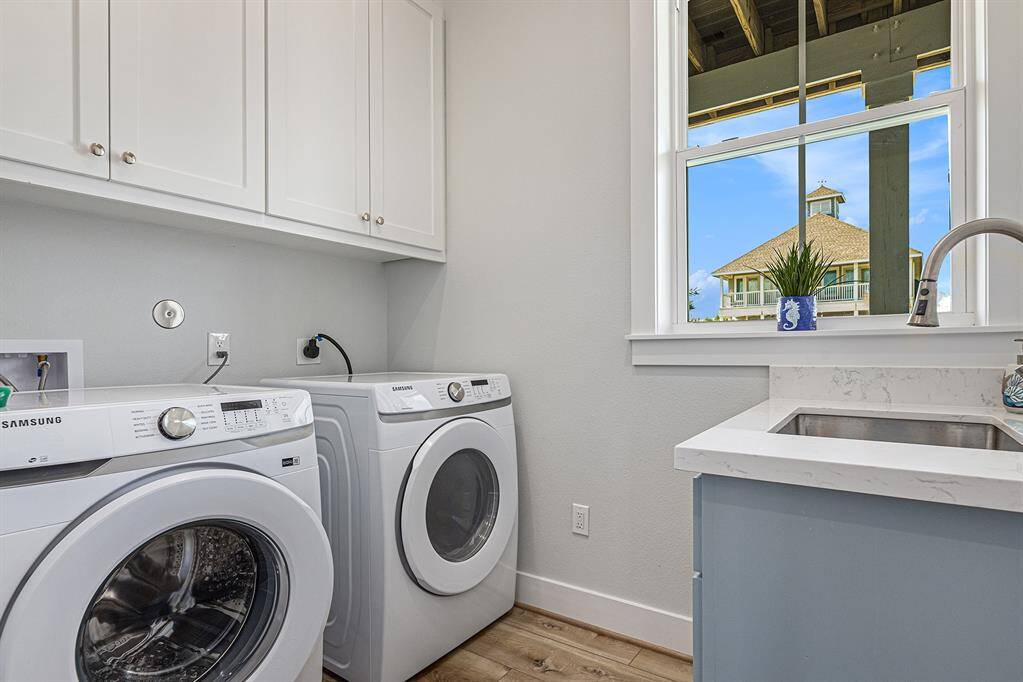 Downstairs laundry room with plenty of space and storage.