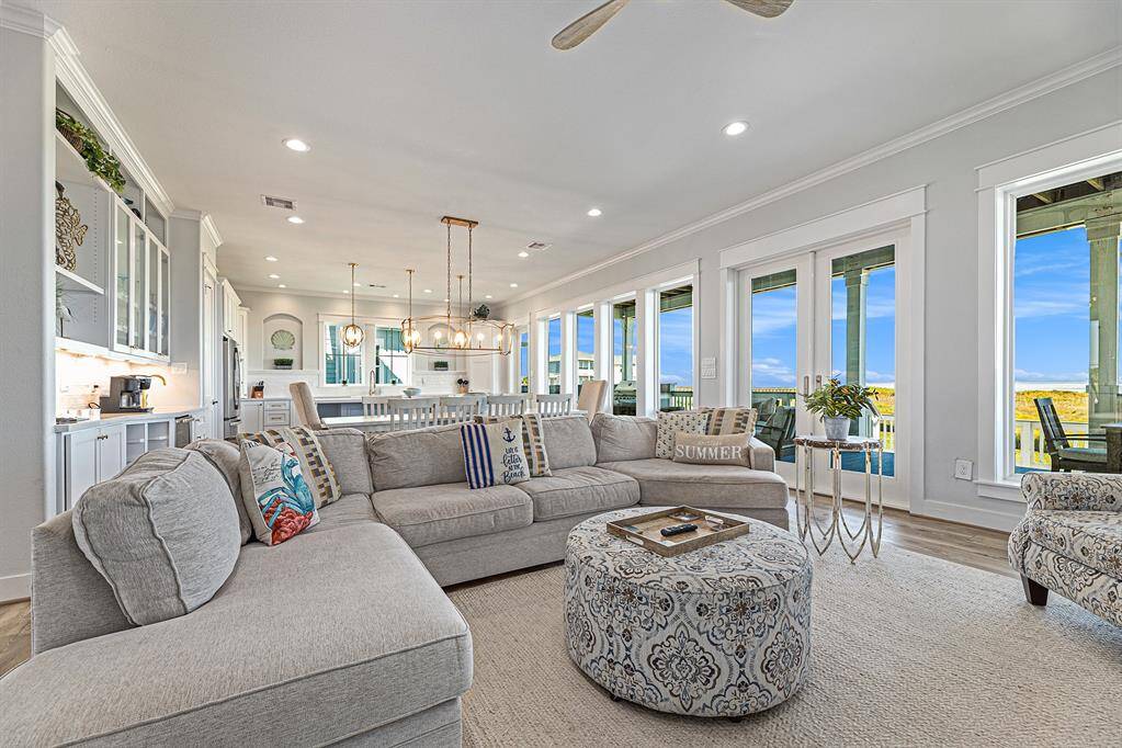 Gorgeous open living room with an open concept that connects to the kitchen and dining room. Huge open windows to allow natural light and to watch the sunrise.