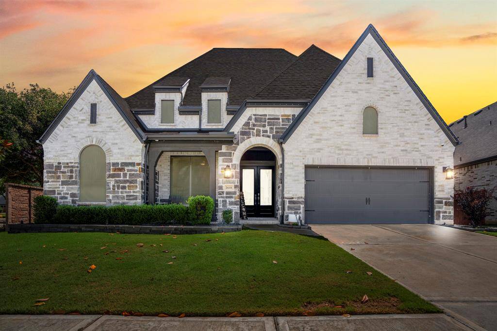 Welcome home to 2618 Coastal Trail! This beautifully crafted home boasts a striking brick exterior with contrasting dark stone and trim, custom landscaping, and sensational curb appeal, creating the perfect first impression.