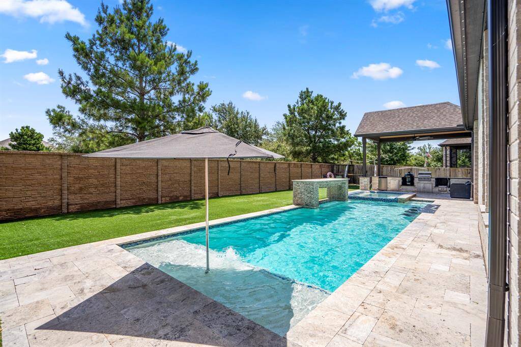 Enjoy resort-style amenities including a sparkling pool and spa, perfect for relaxing or entertaining year-round. Fire up the grill in the fully equipped outdoor kitchen, ideal for alfresco dining. Two spacious covered patios provide ample shade and comfortable seating areas, making indoor-outdoor living effortless. Low-maintenance artificial turf completes the space with lush, green appeal all year long—without the upkeep.
