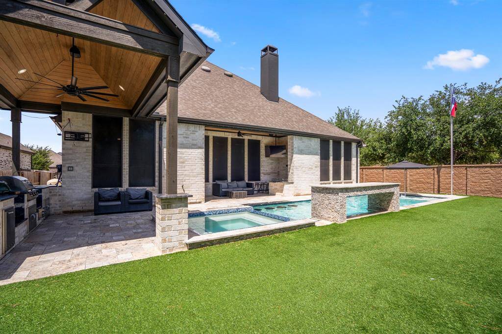 You'll love spending time in the backyard! The current homeowners thought of everything when designing the ultimate backyard escape! Maximizing the space the lot provided by having a pool and spa, as well as an outdoor kitchen, an exterior ceiling fan, artificial turf, and two covered patios!