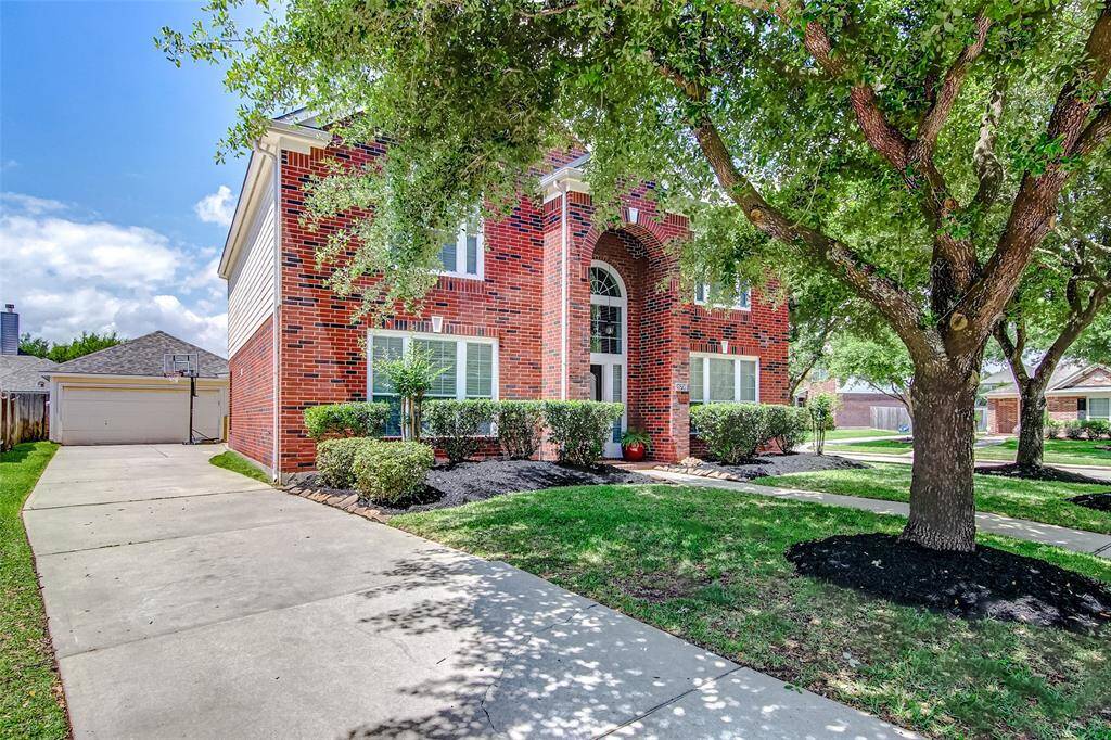 This beautiful home offers exceptional curb appeal, featuring a manicured lawn, lush landscaping, and mature trees. A long driveway guides you to a detached 2-car garage.