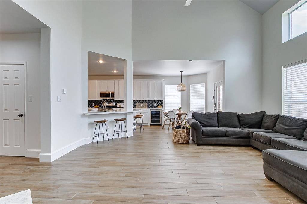 The abundance of light combined with the open design flows effortlessly into the adjacent areas, allowing for seamless interaction between the kitchen, breakfast area, and the rest of the home.