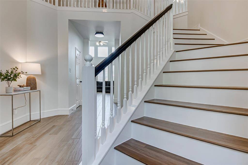 Ascend the elegant wooden staircase to discover three additional spacious bedrooms and a large game room, all located on the second floor, offering plenty of room for relaxation and entertainment.