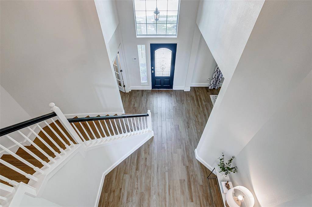 As you reach the landing on the second floor, take a moment to admire the spacious entry, where the open design creates an inviting and airy atmosphere.