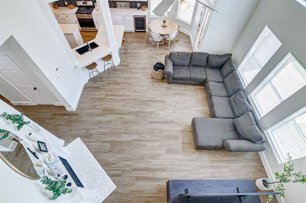 Enjoy a stunning view of the family room from the game room above, where the open design allows you to overlook the spacious, soaring space below, creating a seamless connection between both levels of the home.