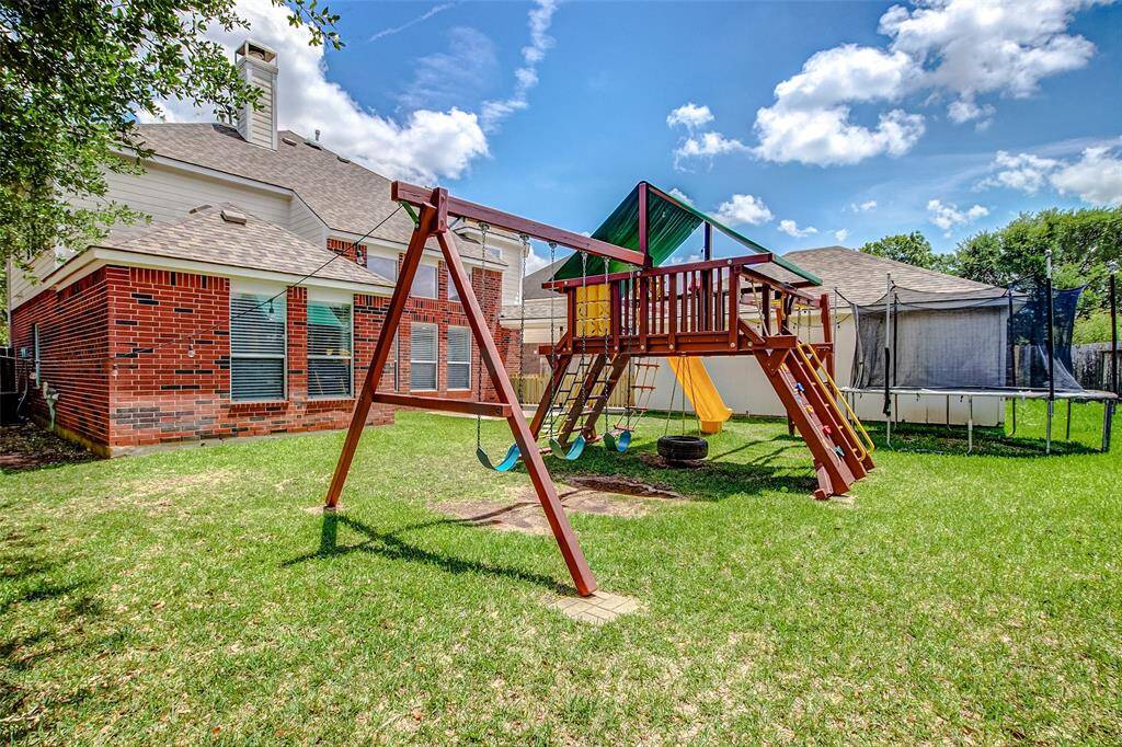 With plenty of green space, this yard is ideal for pets or kids to run and play freely, all within the safety of the fenced-in perimeter.