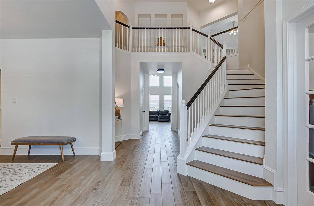 Step inside and be captivated by the soaring ceilings, neutral paint tones, gleaming tile floors, and an abundance of natural light that fills every corner of the home.