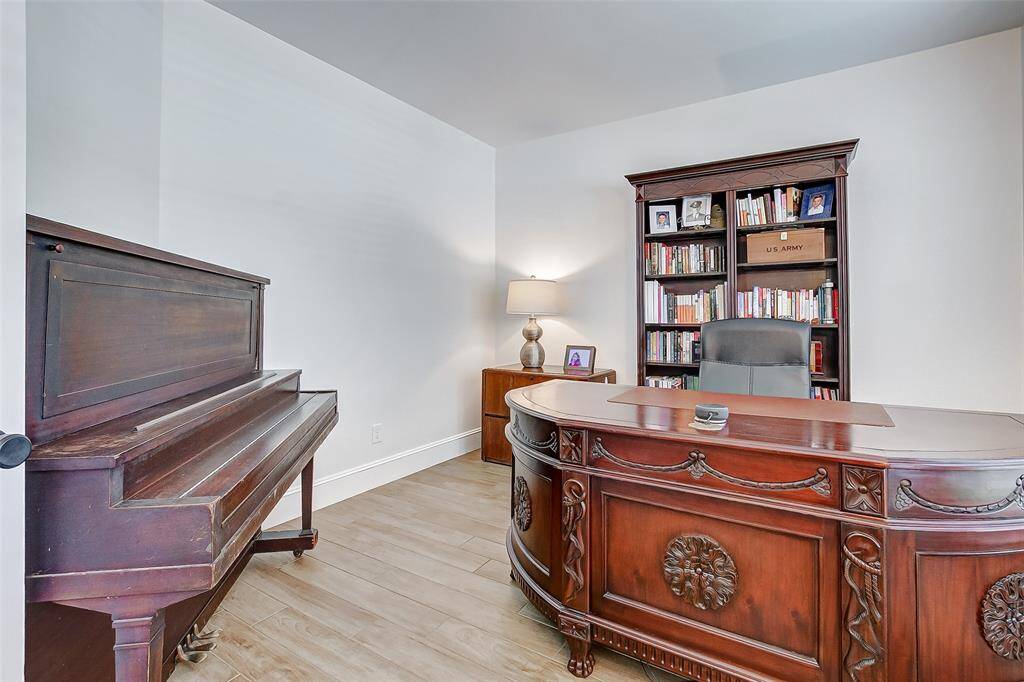 Step through the elegant glass French doors into a spacious home office, perfectly designed to provide a dedicated space for work or study.