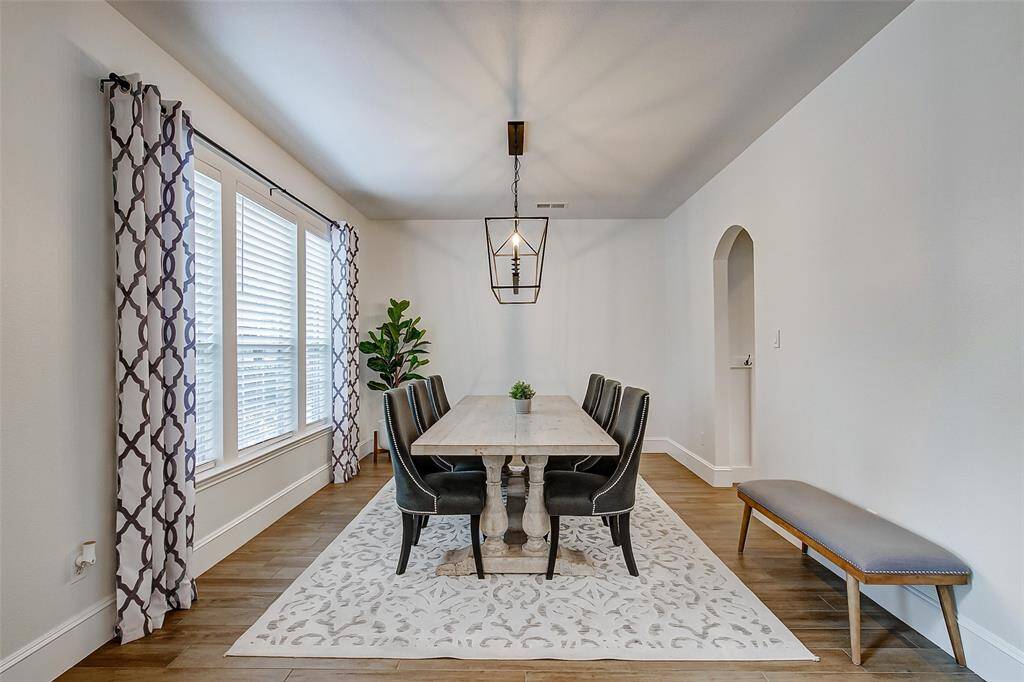 To the left of the entry, you'll find a bright and spacious formal dining room, filled with natural light streaming through large windows.