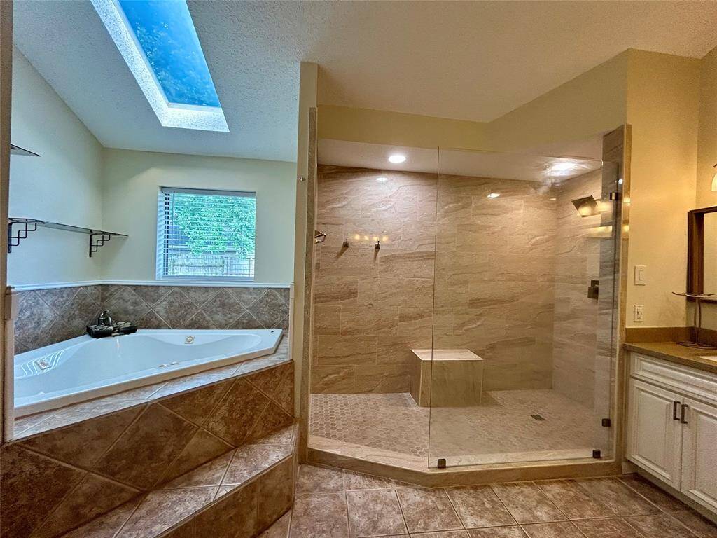 Primary shower and jacuzzi tub.