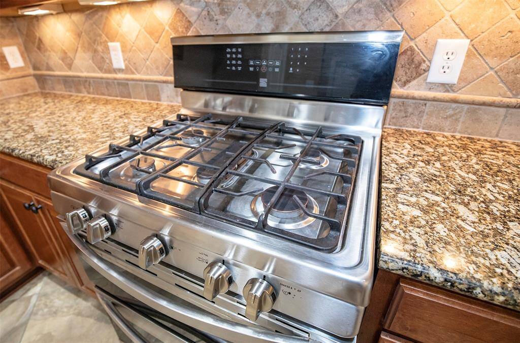 The gourmet five-burner gas stove is sure to please any cook.