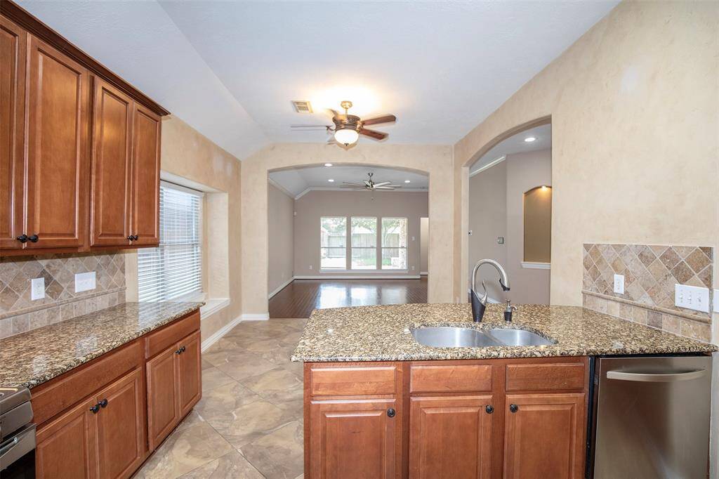 The open layout seamlessly connects the kitchen to the dining area and family room, creating a warm and inviting space where everyone can gather.