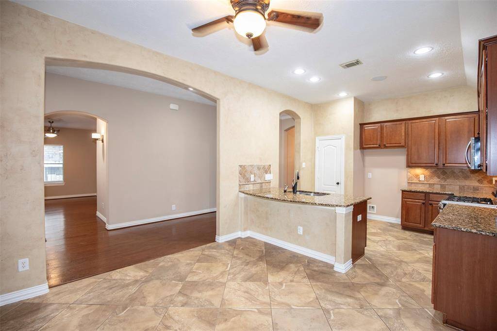 The dining area offers a comfortable and connected space for meals and gatherings, with an open layout that flows effortlessly into both the kitchen and family room.