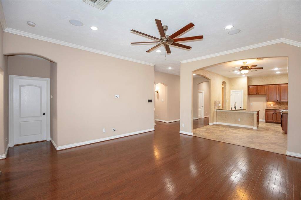 A tall ceiling enhances the open feel of the space and is accented by crown molding, recessed lighting, and a large ceiling fan for comfort and style. It’s the perfect spot to relax or entertain while enjoying the view of the outdoors.