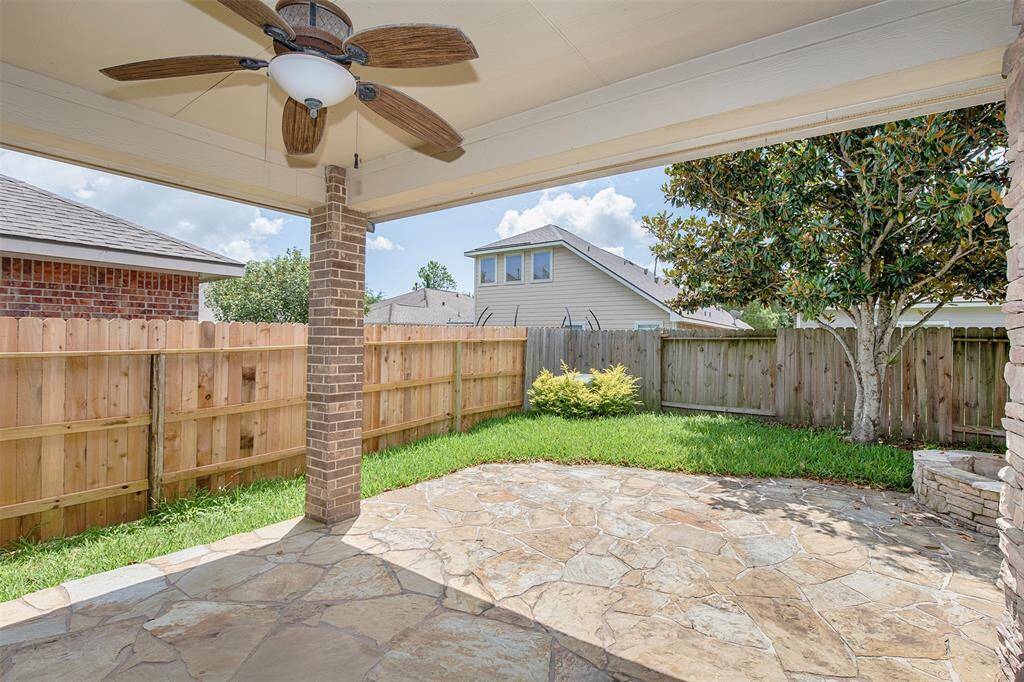 A ceiling fan overhead keeps the space comfortable year-round, making it the perfect spot to relax or entertain.
