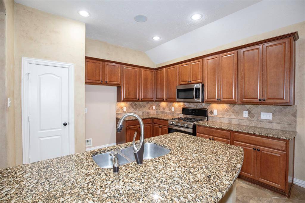 The kitchen boasts recessed lighting.