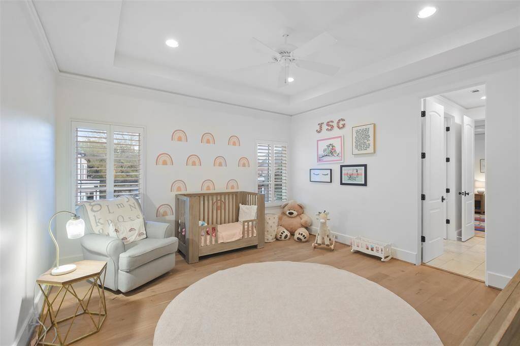 Additional secondary bedroom with coffered ceiling and shutters.