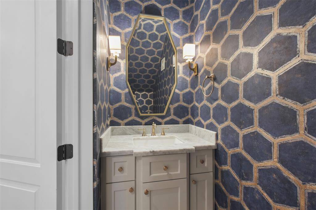 The first floor powder room features designer details and finishes.