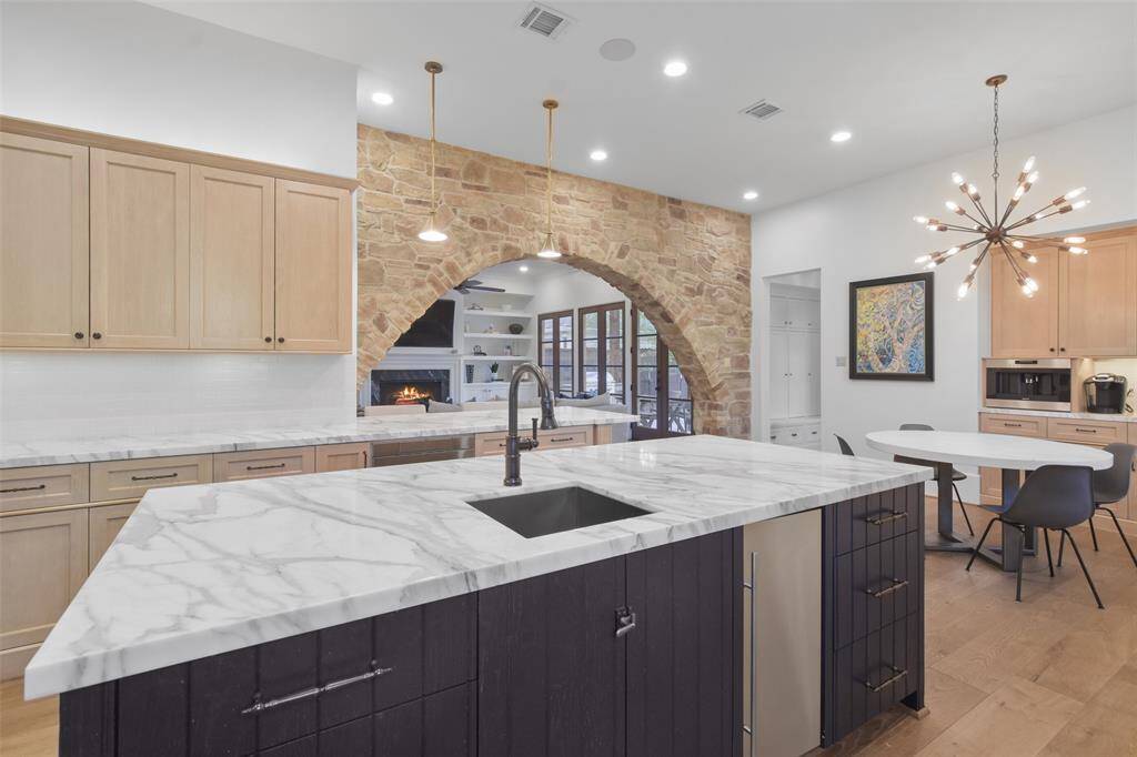 This updated kitchen is a true centerpiece of the home, combining modern functionality with timeless elegance. Custom cabinetry, marble counters, sleek pendant lighting, state-of-the-art appliances that includes a La Cornue range, and thoughtful storage solutions complete the space, making it as beautiful as it is efficient—a dream kitchen designed for both daily living and entertaining.