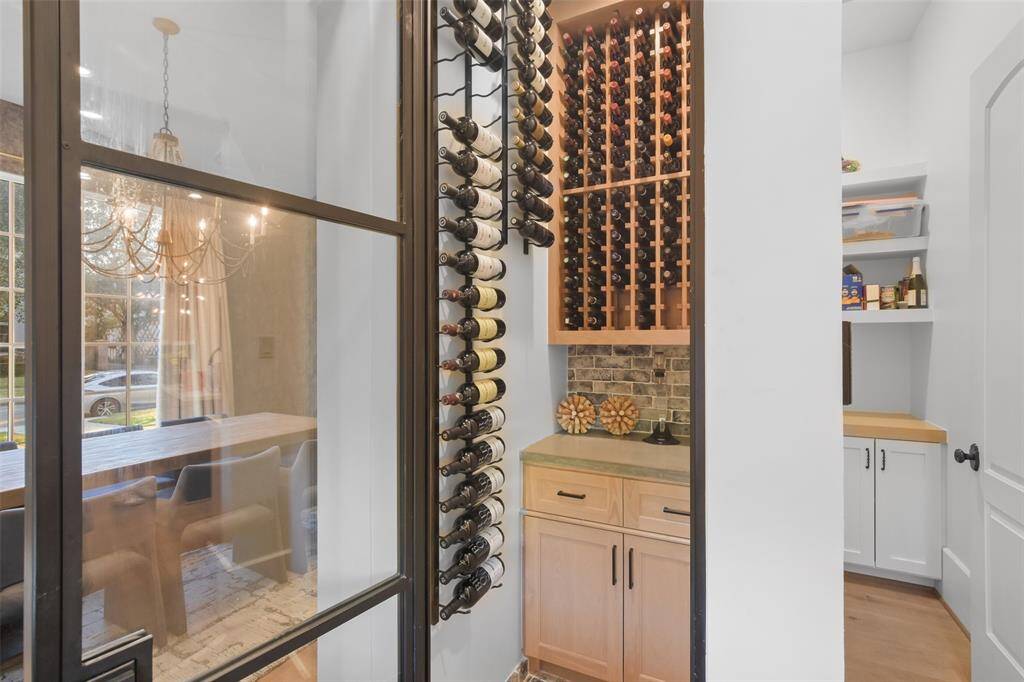 The temperature-controlled wine room ensures your collection is perfectly preserved. Wine racks showcase your collection like a gallery, blending natural wood and sleek metal finishes with a touch of elegance.