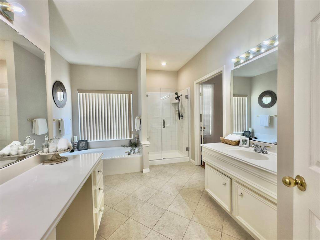 Primary Bath w/ duel vanities, soaking tub and frameless shower.