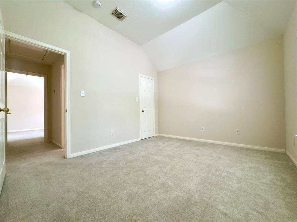 2nd Bedroom (upstairs) with vaulted ceiling and walk-in closet.