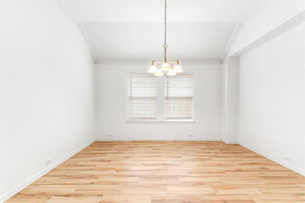 The home features a spacious, open formal dining room filled with natural light and enhanced by upgraded light fixtures, complemented by the same beautiful tile flooring throughout. The large breakfast area offers charming views of the front yard and serves as a versatile space—perfect as a second or third sitting area or a playroom.