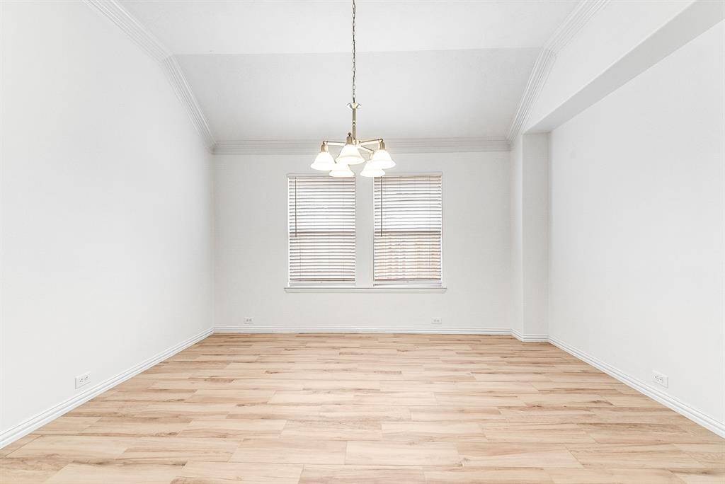 Another view showcases the room’s generous size, featuring two windows—all equipped with full blinds for privacy and light control.